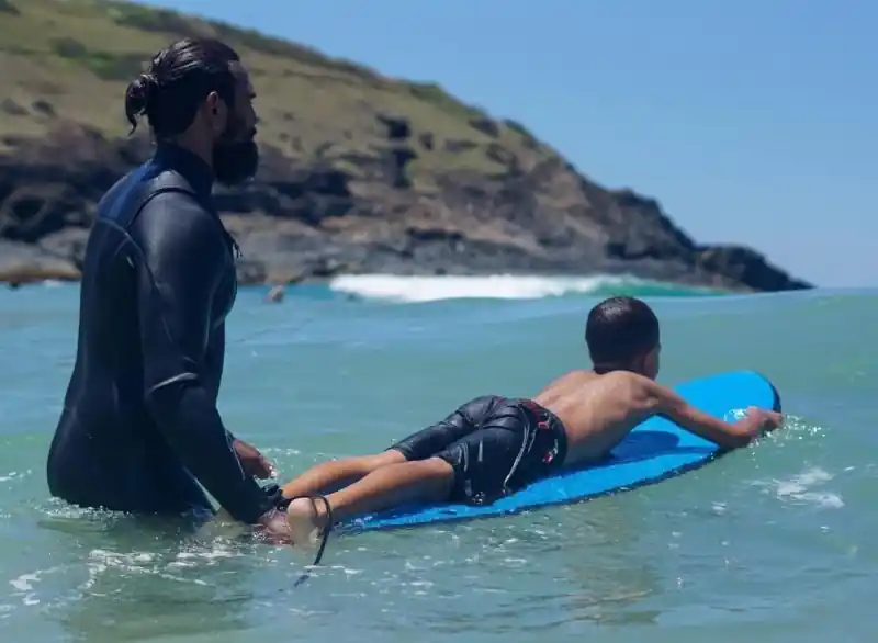 James mentoring youth in the water at Naru Gathering Coffs Harbour
