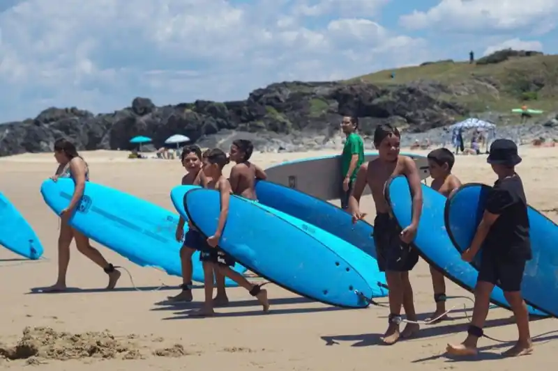 Kids with surfboards at Naru gathering on Gumbaynggirr Country